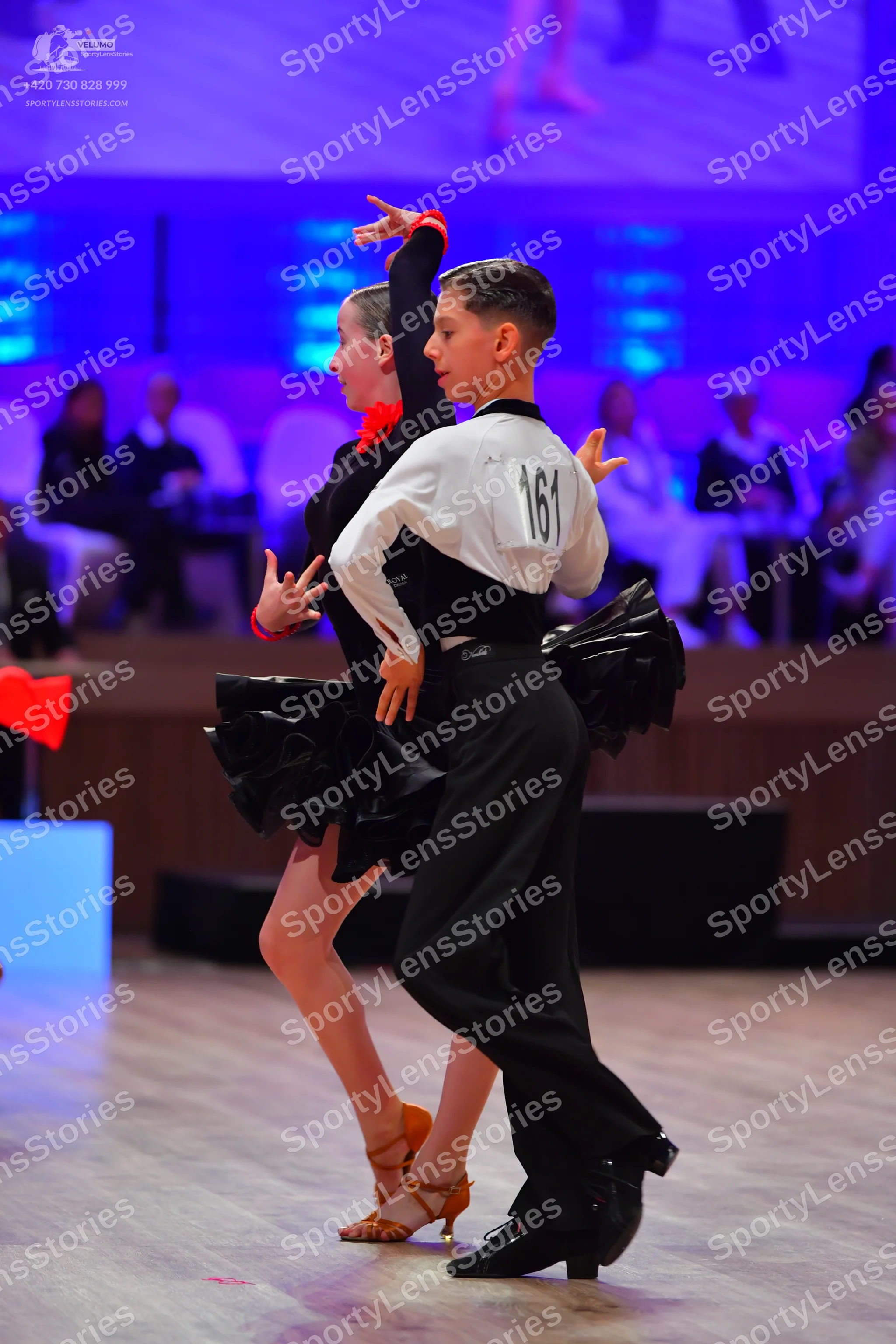 Dancesport competitor: Male dancer: white and black long-sleeved shirt, black trousers, and black dance