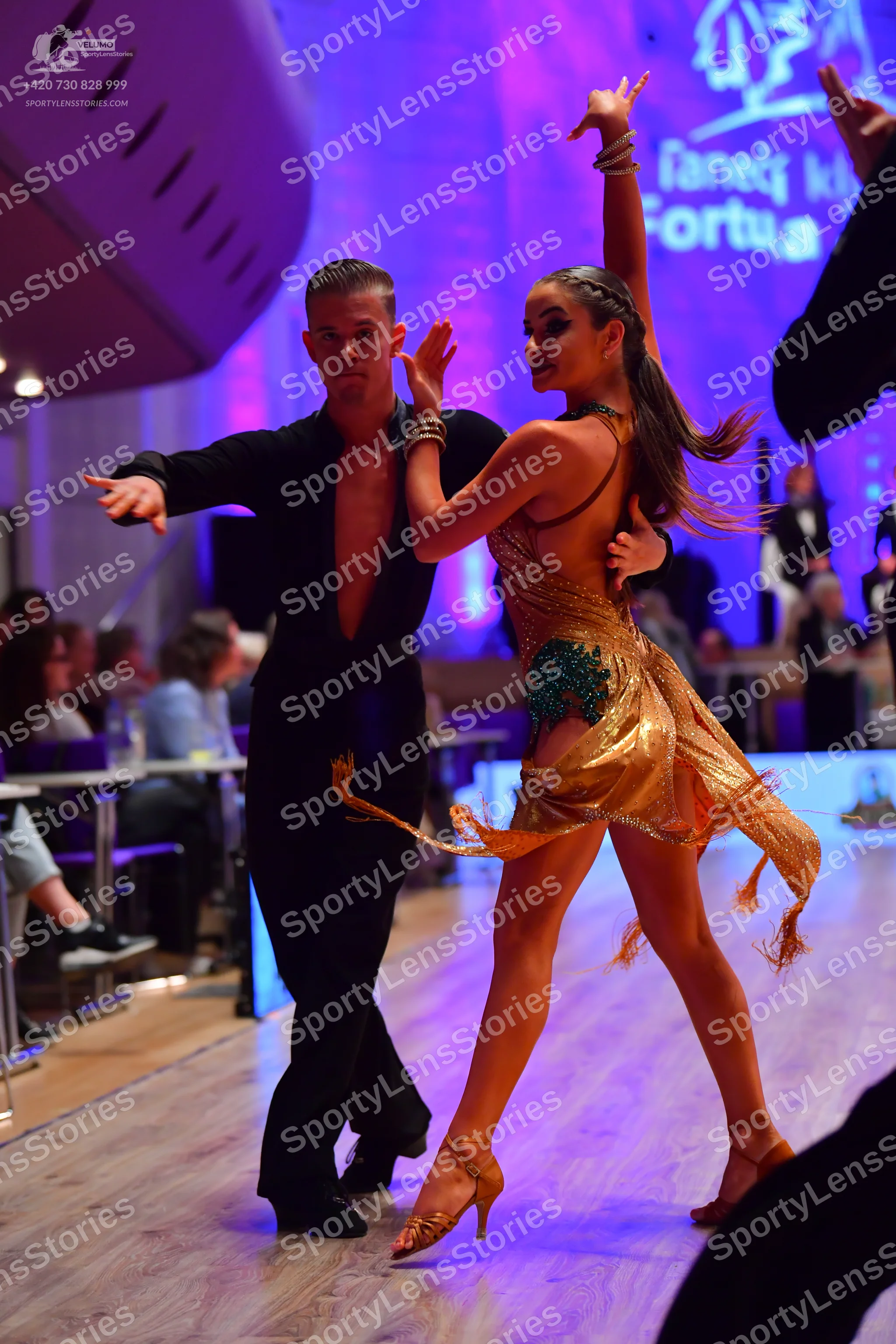 Dancesport competitor: Male dancer: black long-sleeved shirt, open at the chest, and black trousers
