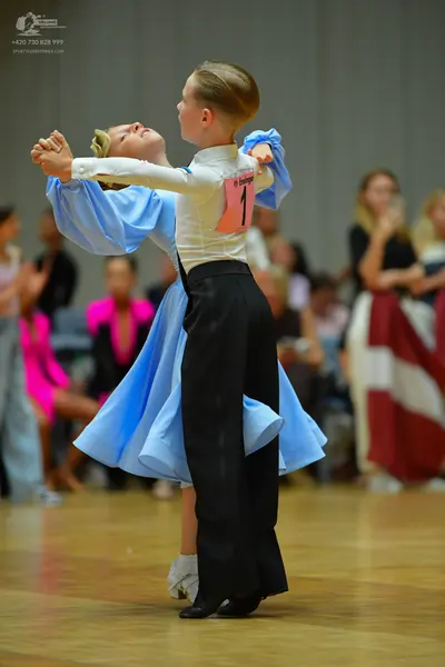 Dancesport competitor: Male dancer: white long-sleeved shirt and black trousers