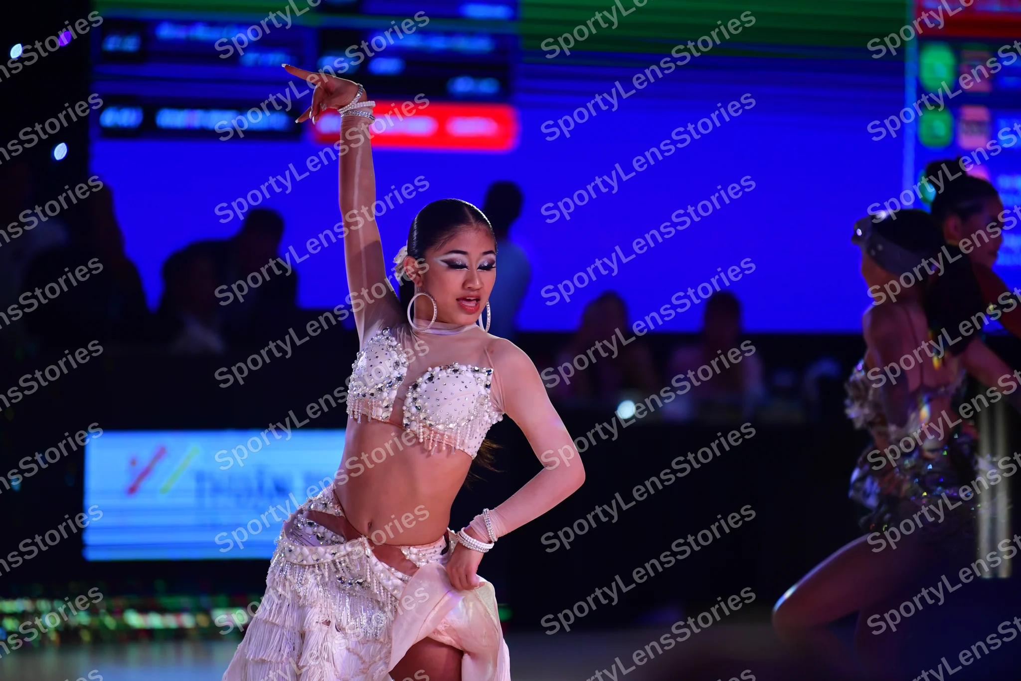 Dancesport competitor: ** White & Silver Latin Dress
*   **Colors:** Primarily white with silver sequin