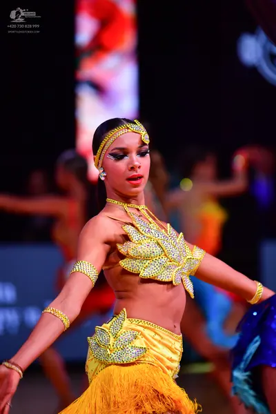 Dancesport competitor: Main female dancer: yellow Latin costume with silver/white sequin/rhinestone emb