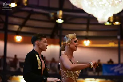 Dancesport competitor: Male dancer: black Latin dance shirt with gold embellishments