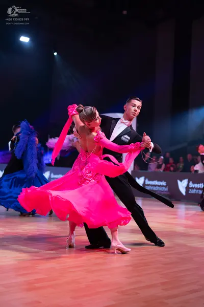 Dancesport competitor: Male dancer: black suit with a white shirt and black bowtie