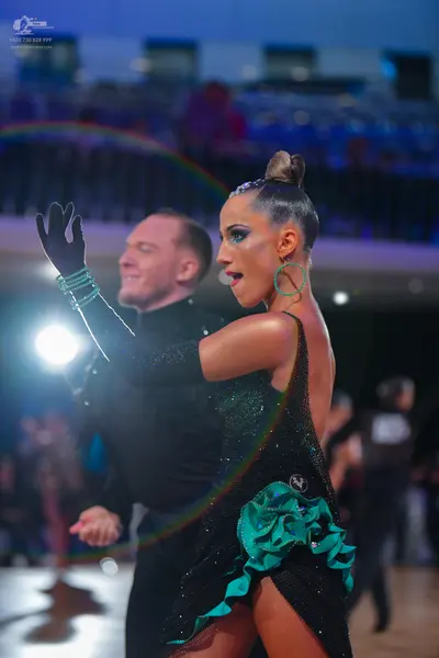 Dancesport competitor: Male dancer: black long-sleeved top