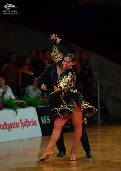Dancesport competitor: Male dancer: black long-sleeved Latin dance shirt and black trousers