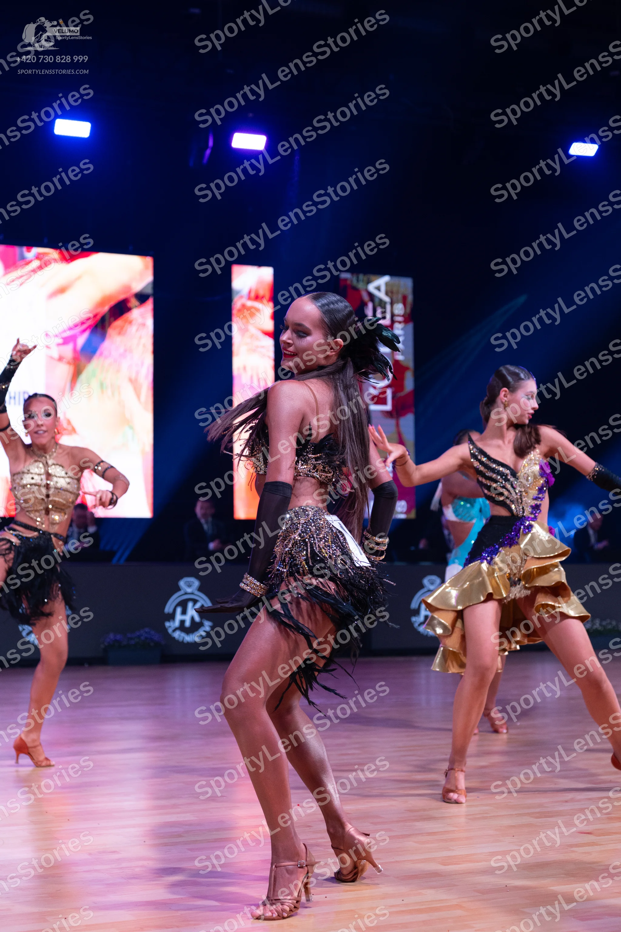 Dancesport competitor: Female dancer 1: gold sequin Latin dress