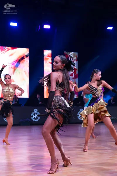 Dancesport competitor: Female dancer 1: gold sequin Latin dress