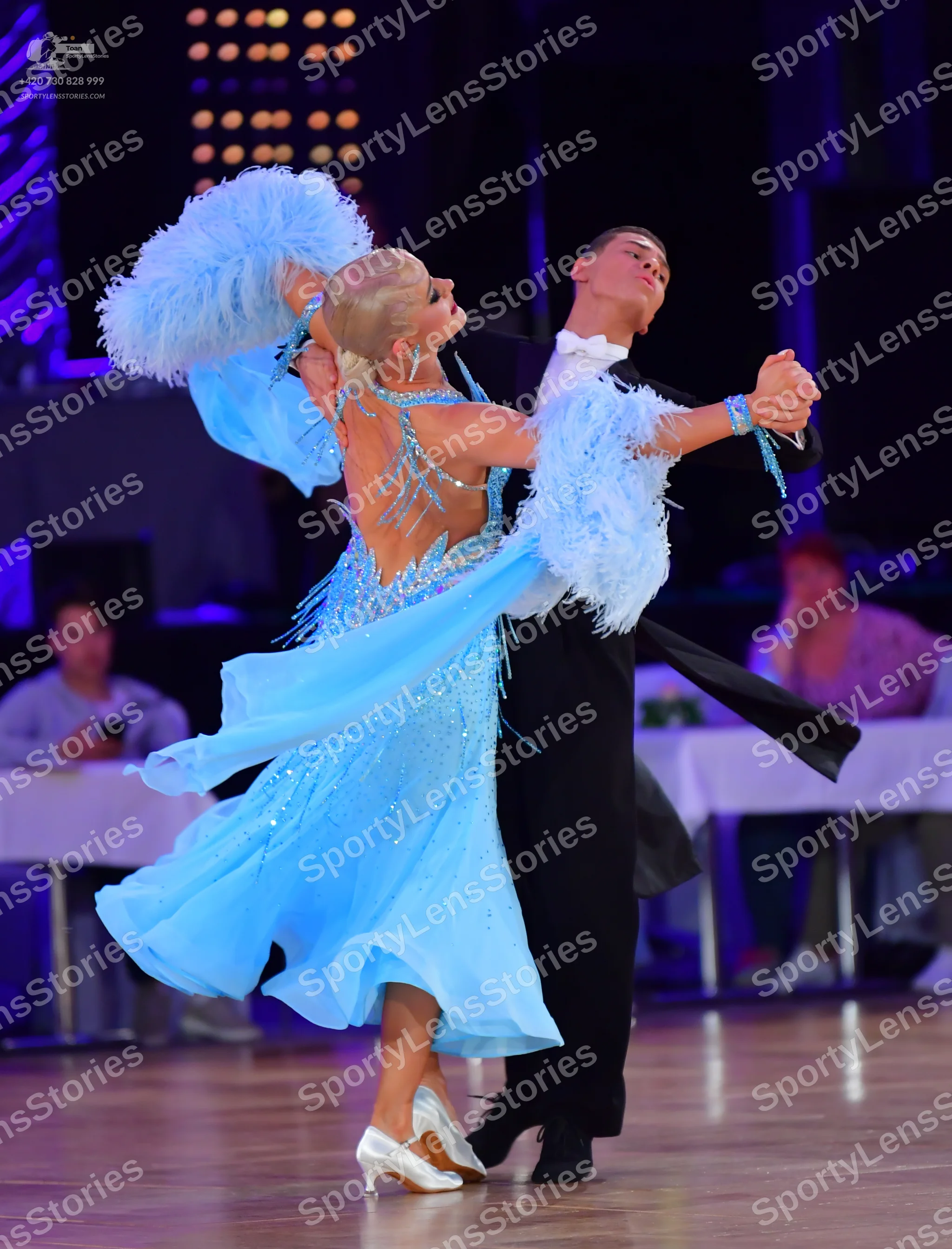 Dancesport competitor: Female dancer: light blue ballroom dress with silver sequins and large, fluffy l