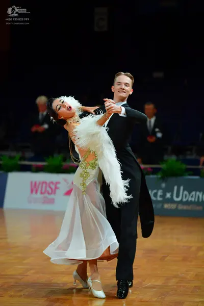 Dancesport competitor: Male dancer: black suit, white shirt, and black bowtie