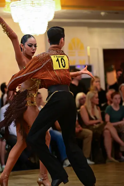 Dancesport competitor #10: Male dancer: bronze-colored long-sleeved shirt with sequin embellishments and bl