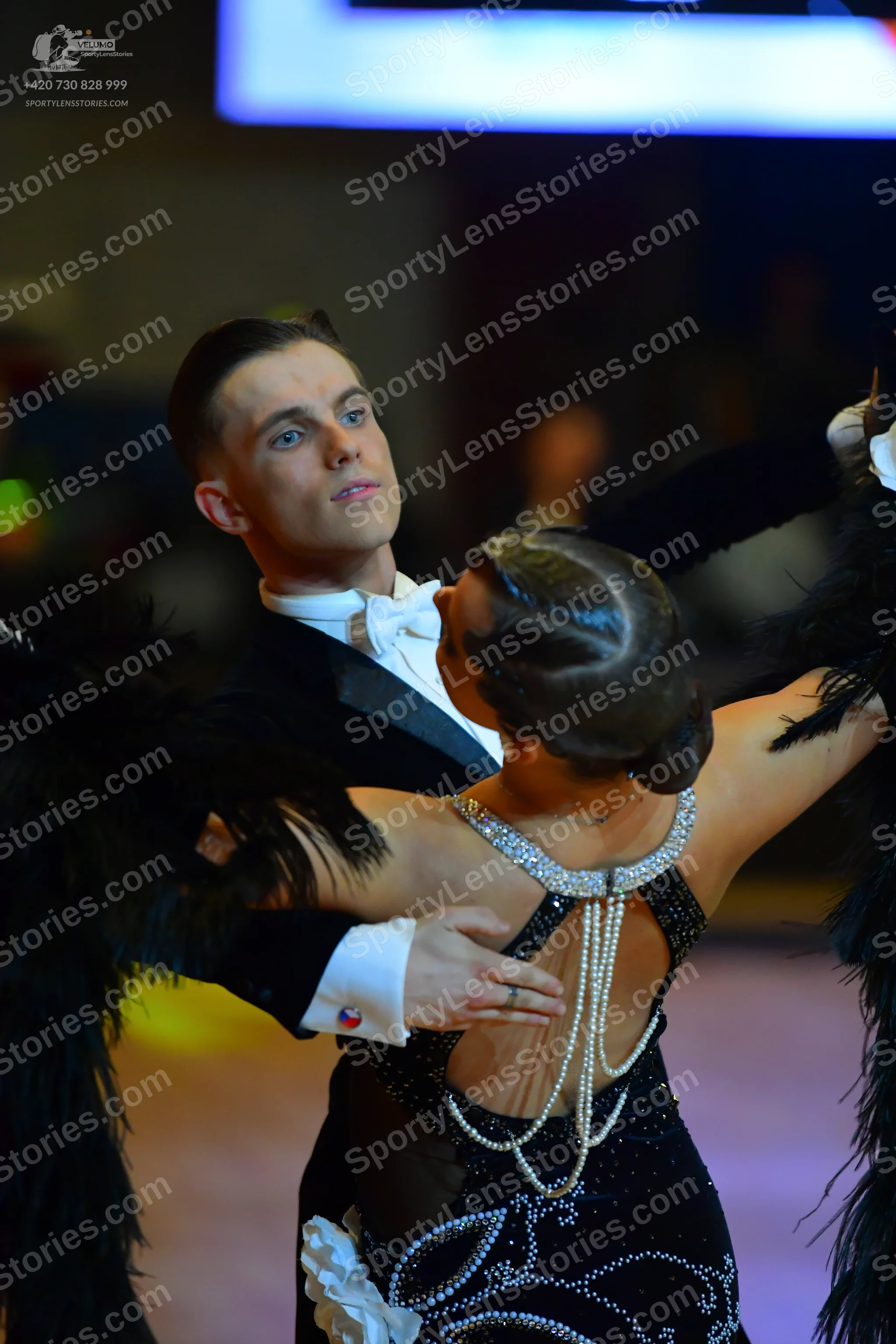 Dancesport competitor: Male dancer: black suit with a white shirt and white bow tie