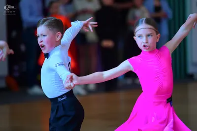 Dancesport competitor: Male dancer: white long-sleeve shirt with a black bow tie and black trousers