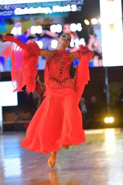 Dancesport competitor: Female dancer: red latin dress with fringe