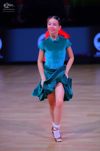 Dancesport competitor: Female dancer: teal satin-like short-sleeved dress with a high neck and a flared