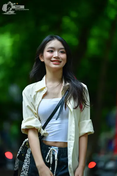 Dancesport competitor: The person is wearing casual clothing, consisting of a white tank top, an open o