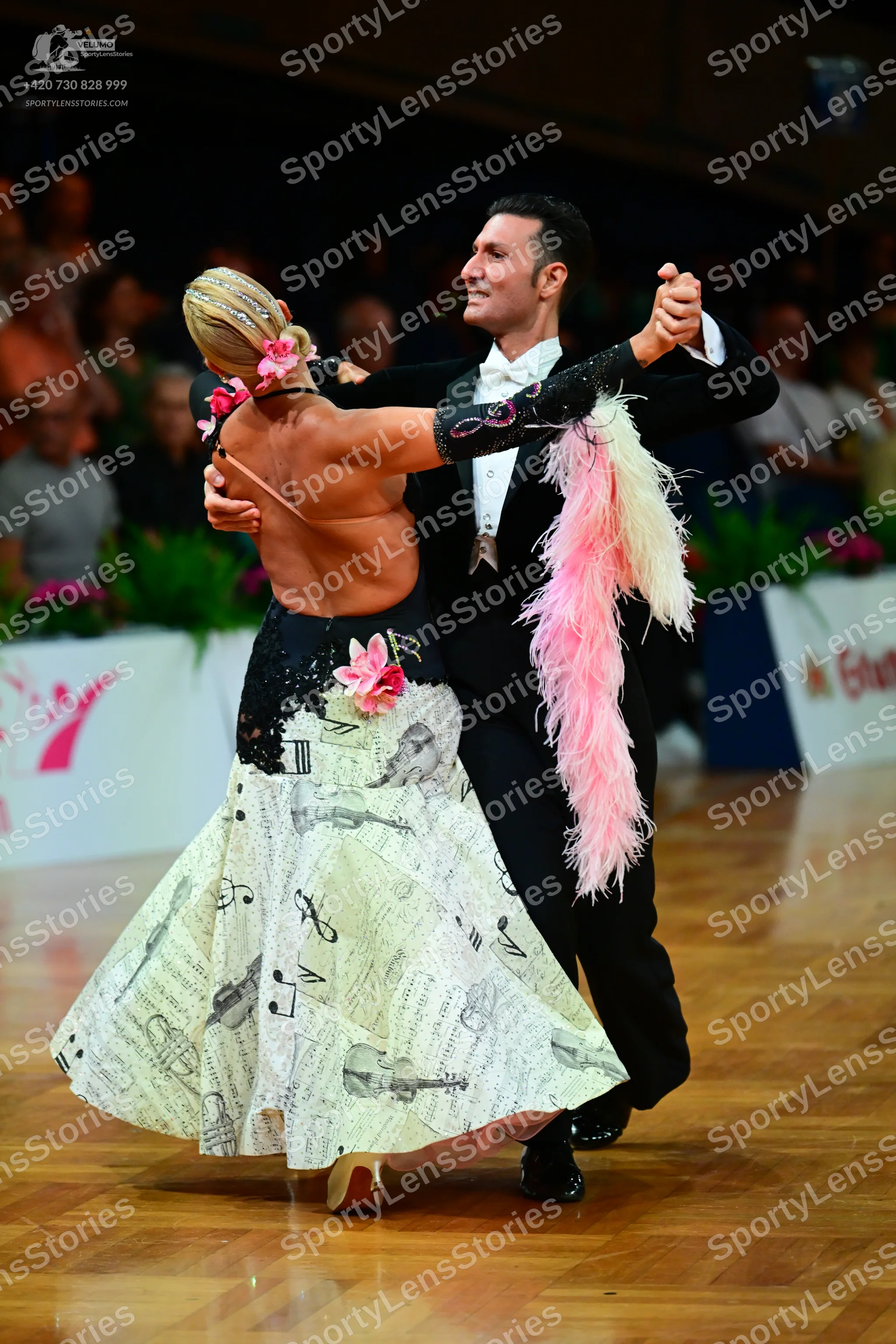 Dancesport competitor: Male dancer: black suit with a white shirt and a white bow tie