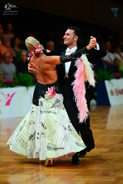 Dancesport competitor: Male dancer: black suit with a white shirt and a white bow tie