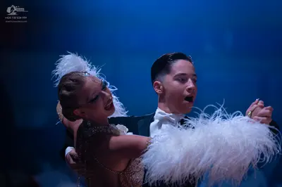 Dancesport competitor: Male dancer: black suit with a white shirt