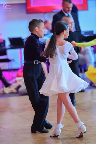 Dancesport competitor: Male dancer: black long-sleeved turtleneck and black trousers