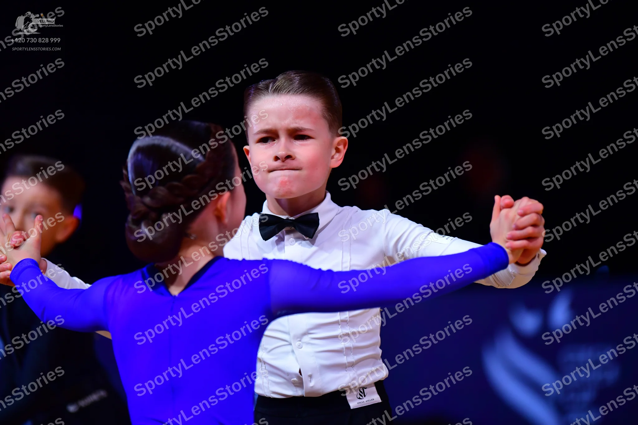 Dancesport competitor: Male dancer: white long-sleeved shirt, black bow tie, and black trousers