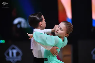 Dancesport competitor: Male dancer: white long-sleeve shirt and black trousers