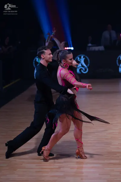 Dancesport competitor: Male dancer: black long-sleeved dance shirt and black trousers