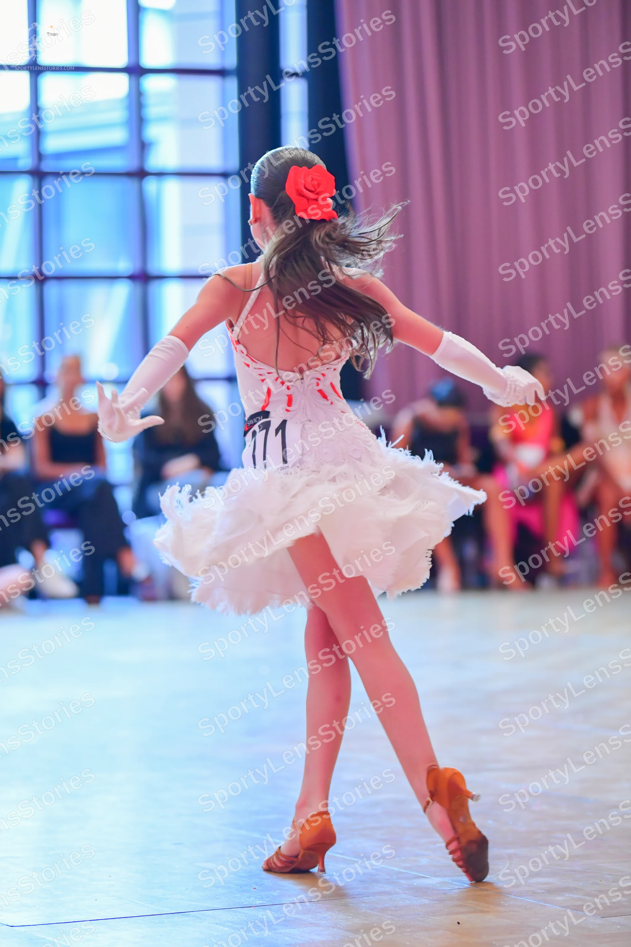 Dancesport competitor #771: Female dancer: white ruffled Latin dance dress with red accents, long white glov