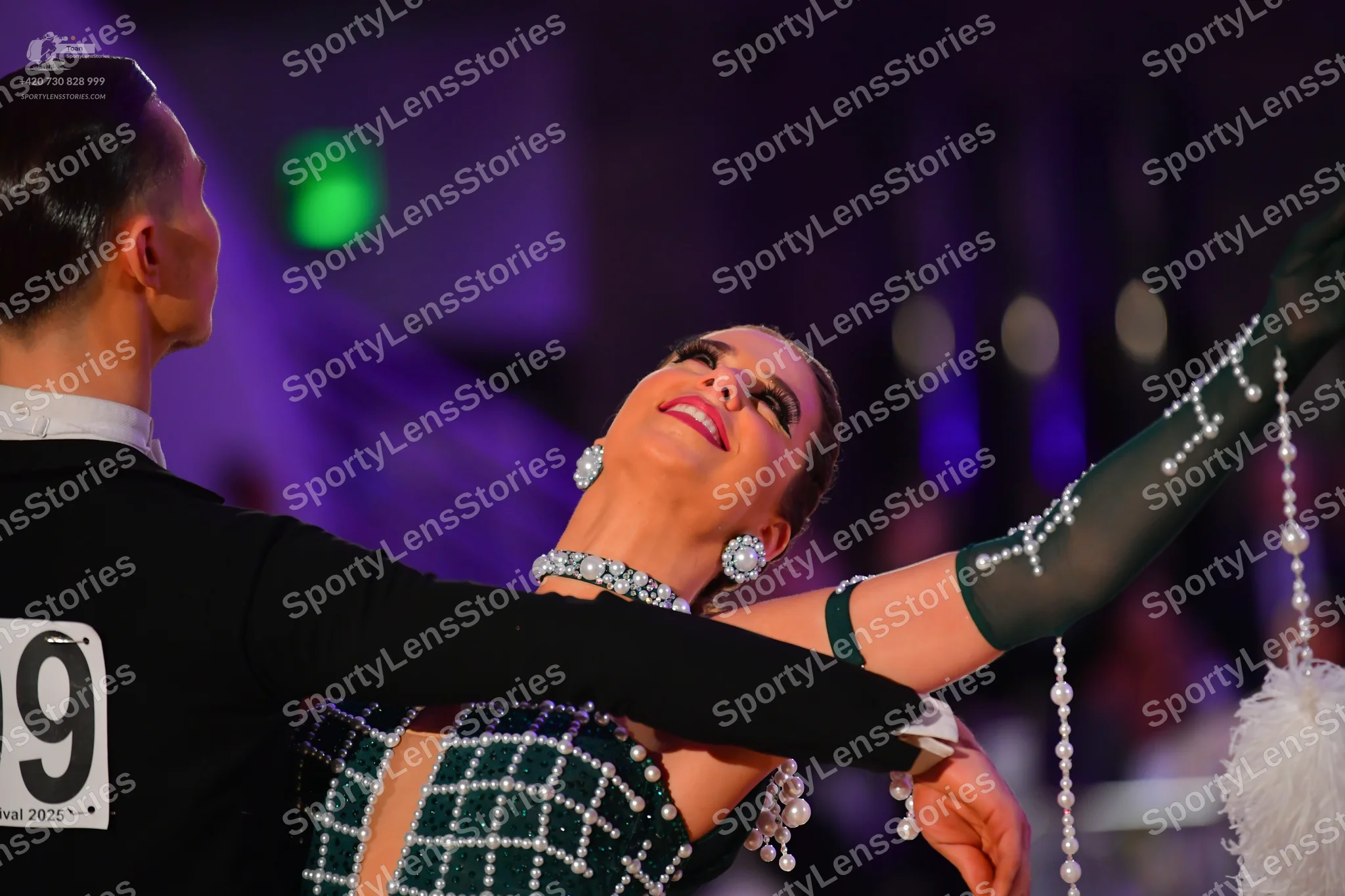 Dancesport competitor: Male dancer: black long-sleeved suit jacket with a white shirt collar visible