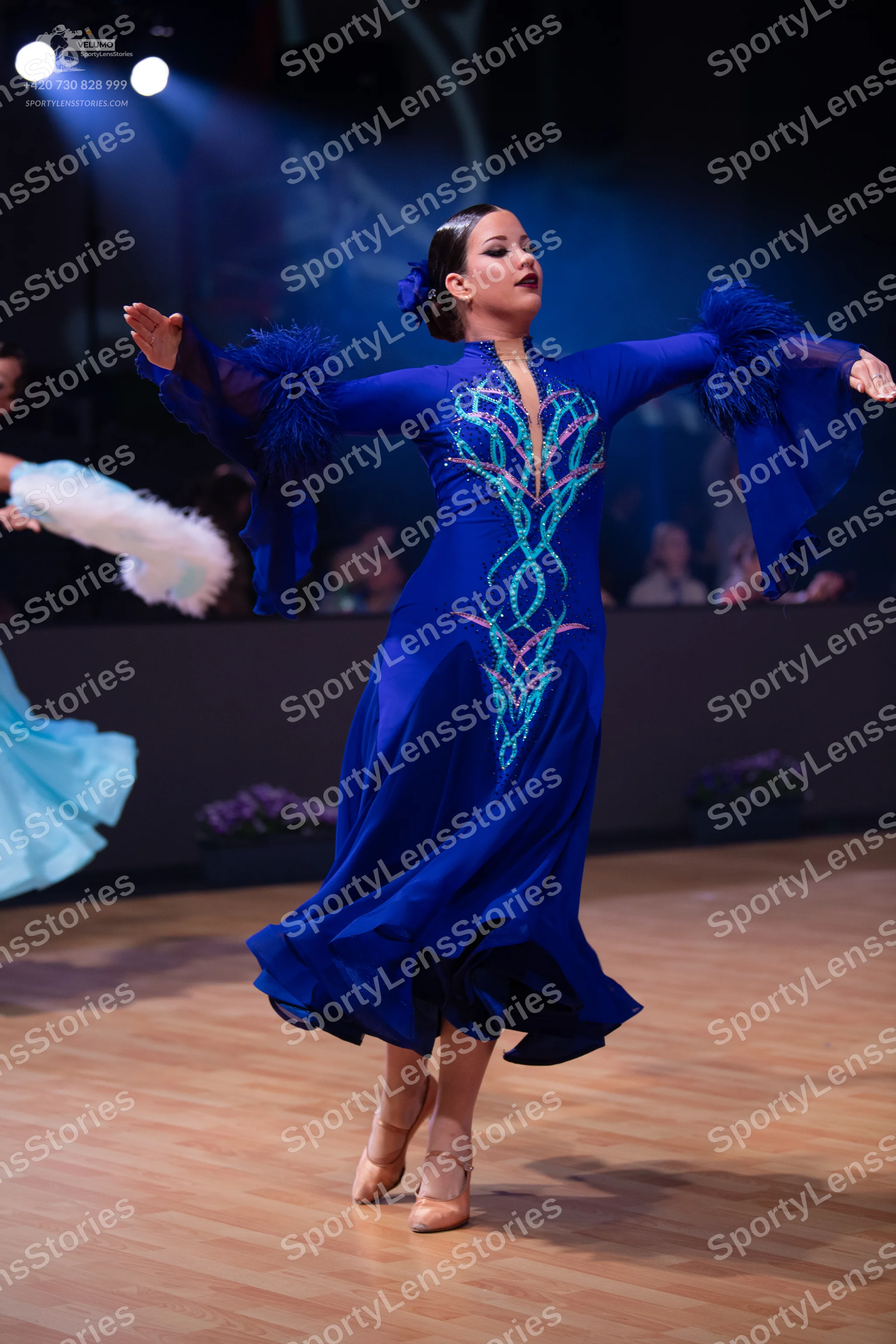 Dancesport competitor: Female dancer: royal blue ballroom gown with silver and light blue sequin patter