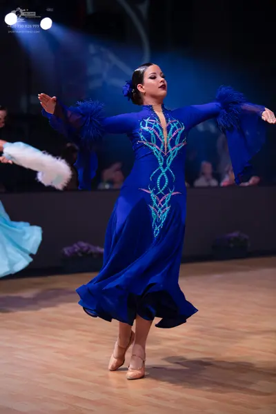 Dancesport competitor: Female dancer: royal blue ballroom gown with silver and light blue sequin patter