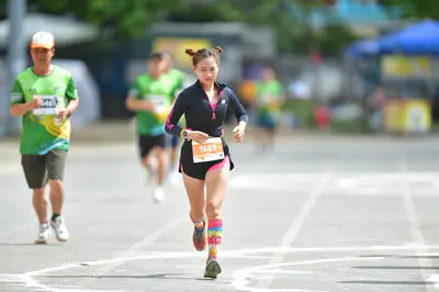 Marathon runner #1668, #1661: Runner 1: black long-sleeved top, black shorts, colorful tall socks, dark shoes