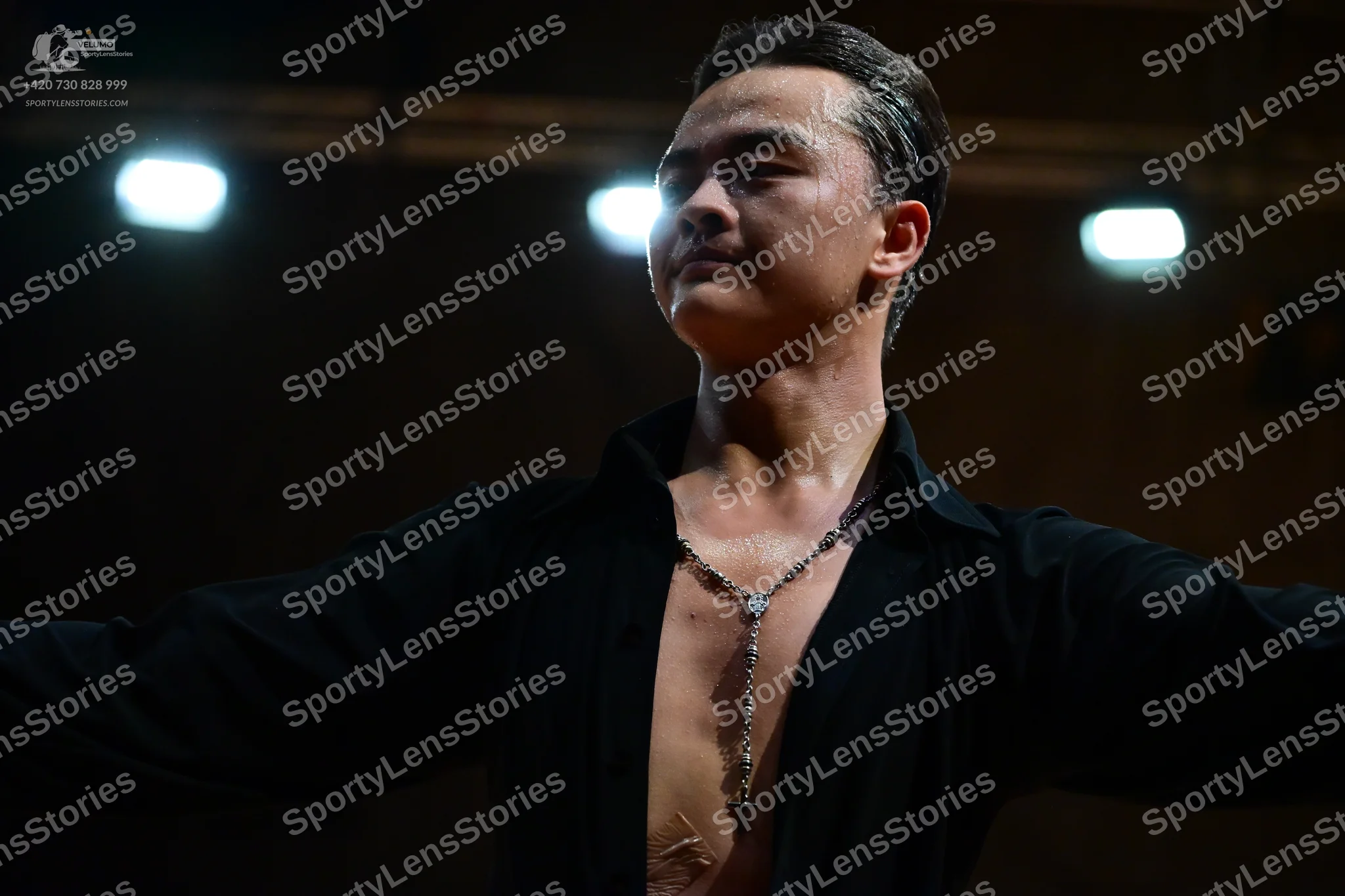 Dancesport competitor: Male dancer: black shirt, unbuttoned at the chest