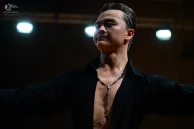 Dancesport competitor: Male dancer: black shirt, unbuttoned at the chest