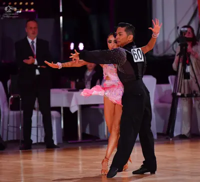 Dancesport competitor #60: Male dancer: black long-sleeved shirt with silver sequins on the sleeve and blac