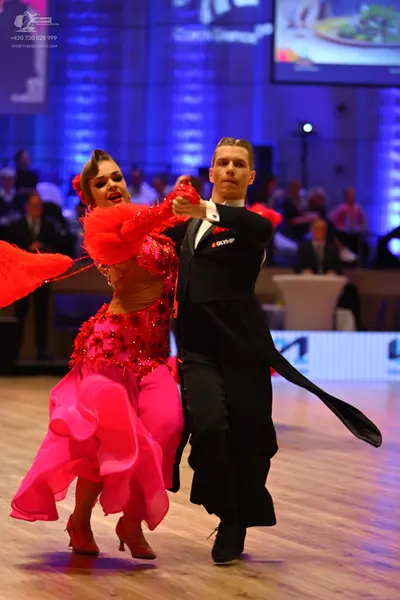 Dancesport competitor: Female dancer: pink latin dress with sequins and a ruffled skirt