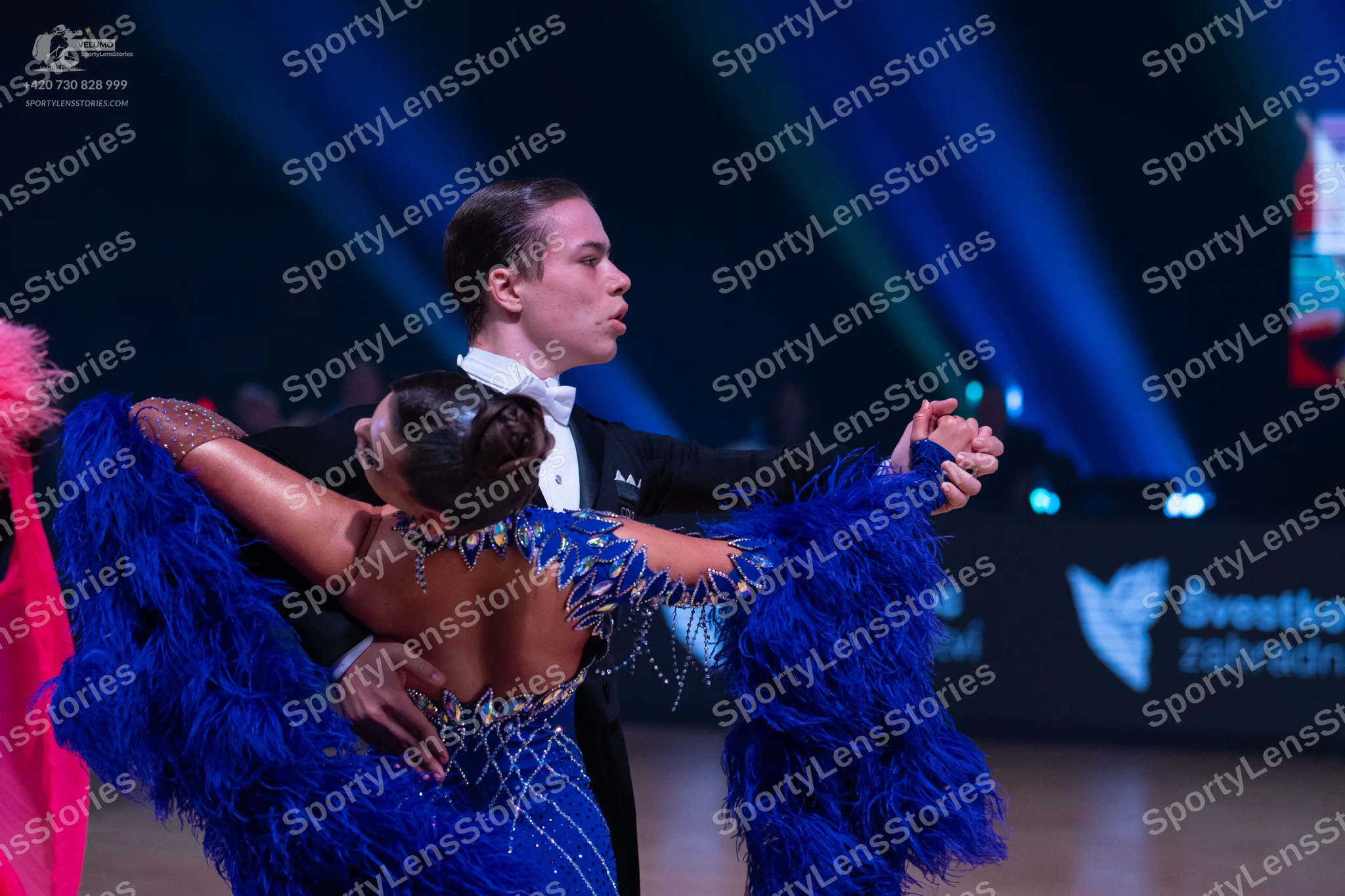 Dancesport competitor: Male dancer: black suit with a white shirt and white bow tie