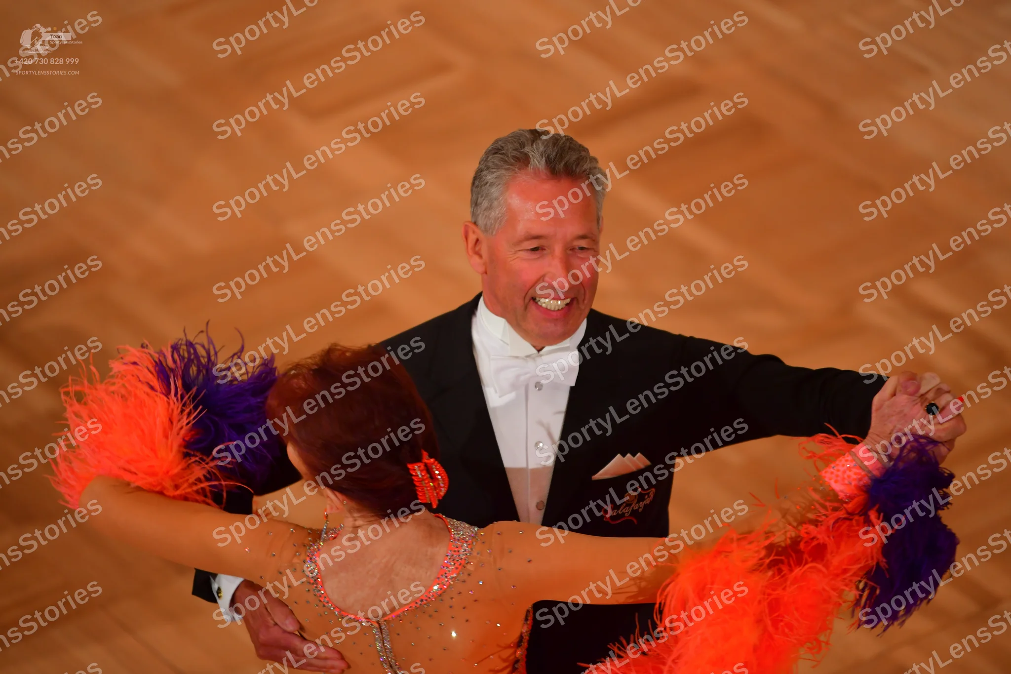 Dancesport competitor: Male dancer: black suit with white shirt and white bowtie