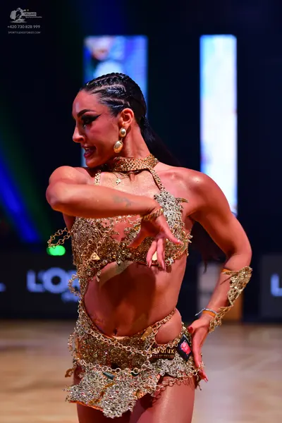Dancesport competitor: Female dancer: gold, heavily sequined and crystal-embellished Latin dance costum