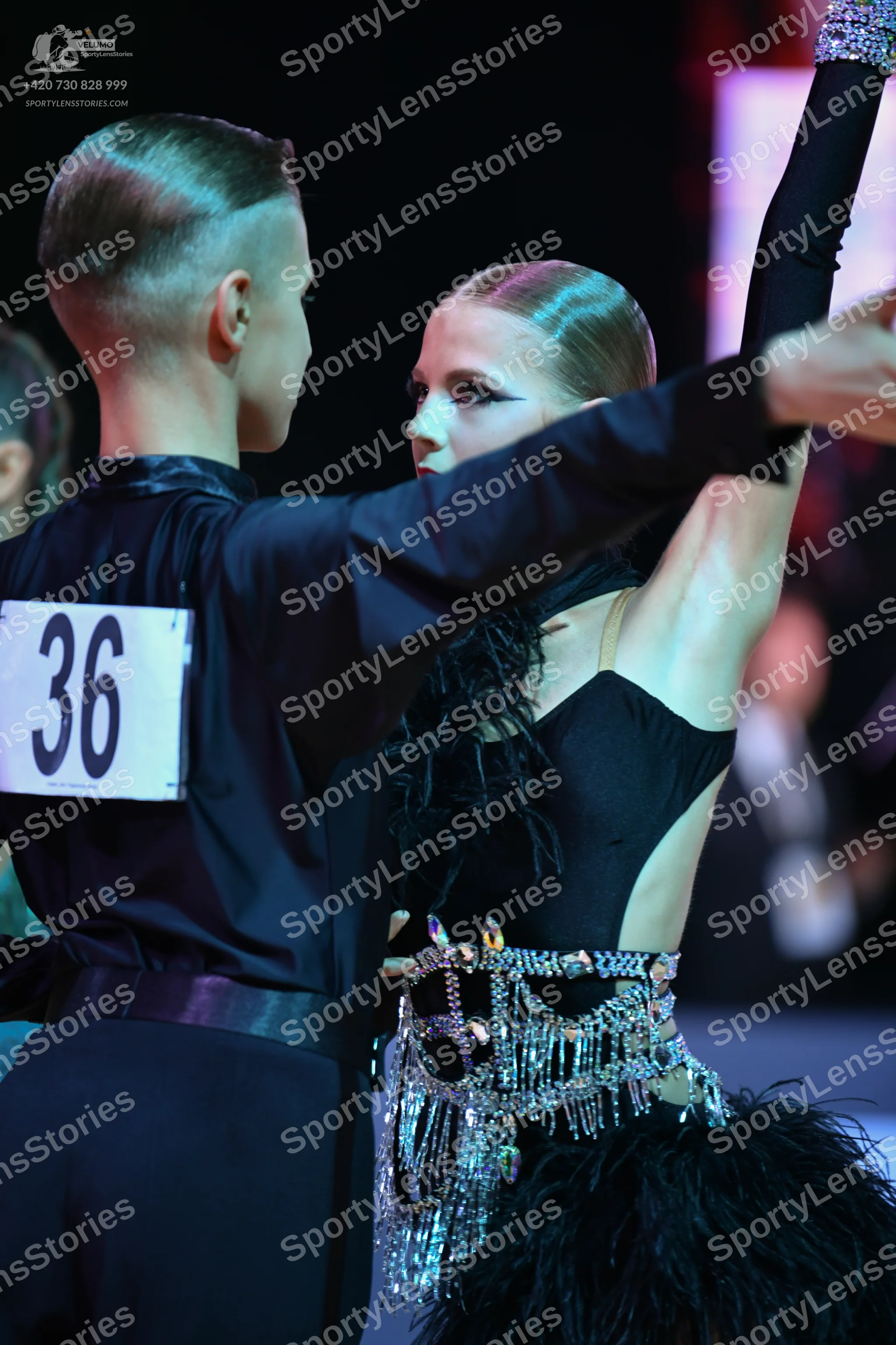 Dancesport competitor: Male dancer: black long-sleeved shirt and black trousers with a black belt
