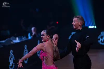 Dancesport competitor: Male dancer: black long-sleeved dance shirt and black trousers
