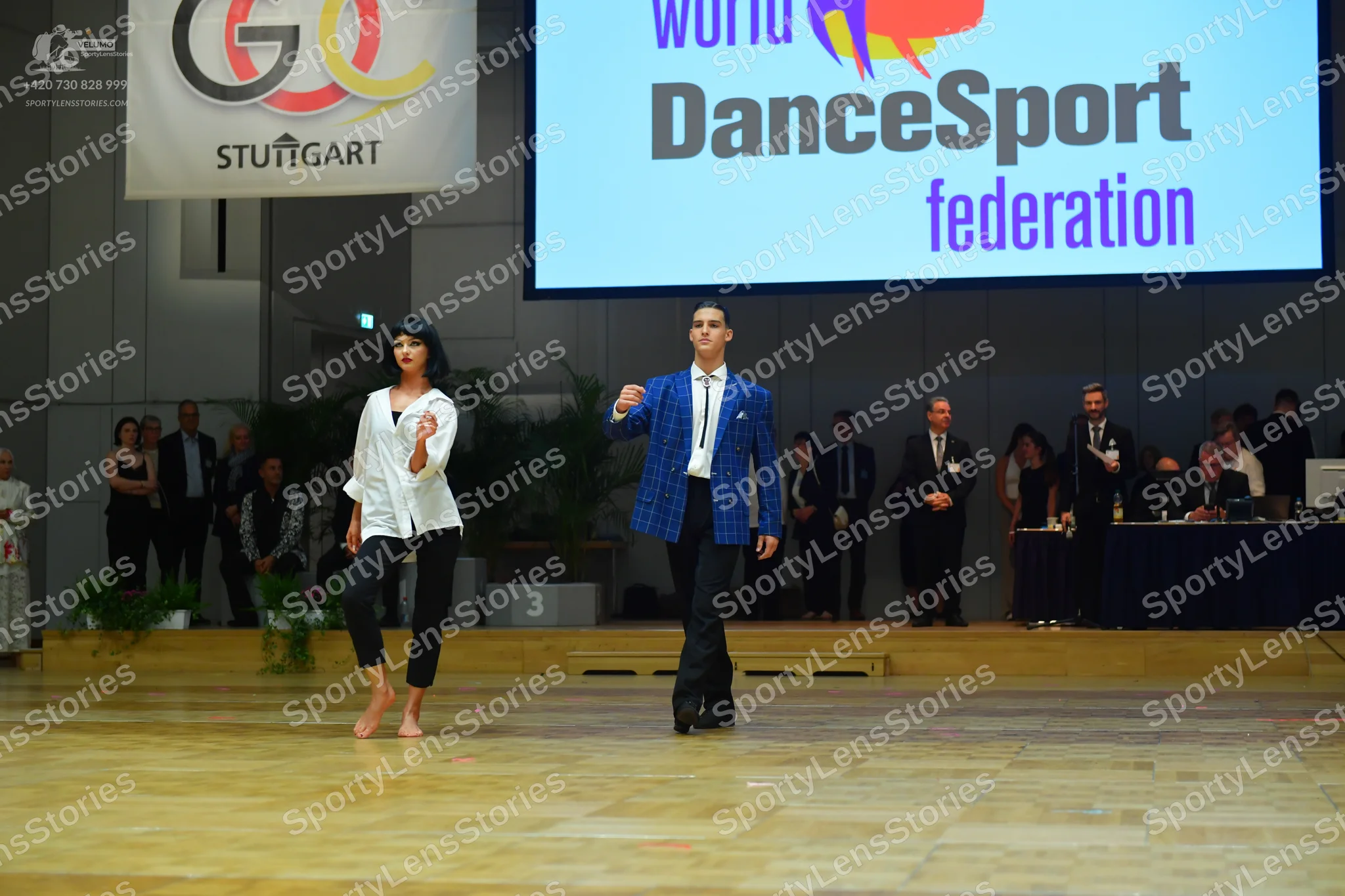 Dancesport competitor: Male dancer: blue textured jacket, white shirt, and black trousers