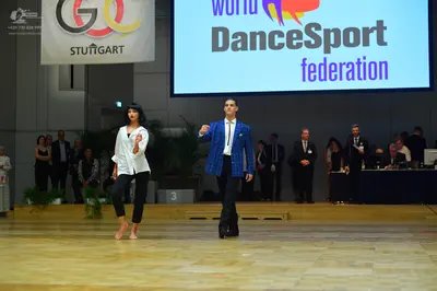 Dancesport competitor: Male dancer: blue textured jacket, white shirt, and black trousers