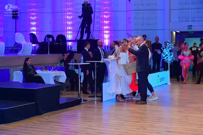 Dancesport competitor: Man dancer: dark suit with a white shirt