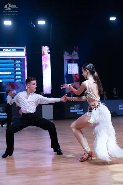Dancesport competitor: Male dancer: white long-sleeved shirt and black trousers