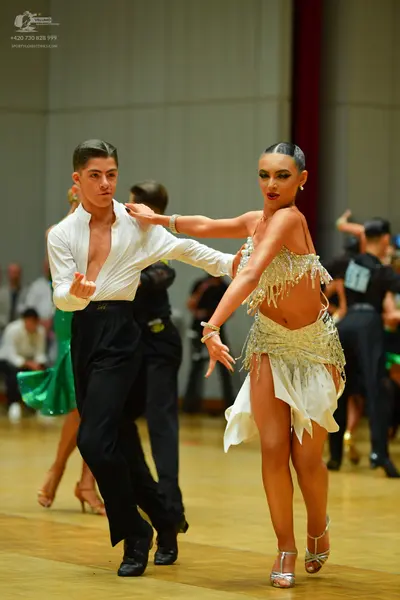 Dancesport competitor: Male dancer: white long-sleeved shirt and black trousers