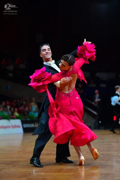 Dancesport competitor: Male dancer: black tailcoat, white shirt, black bowtie, and black patent leather