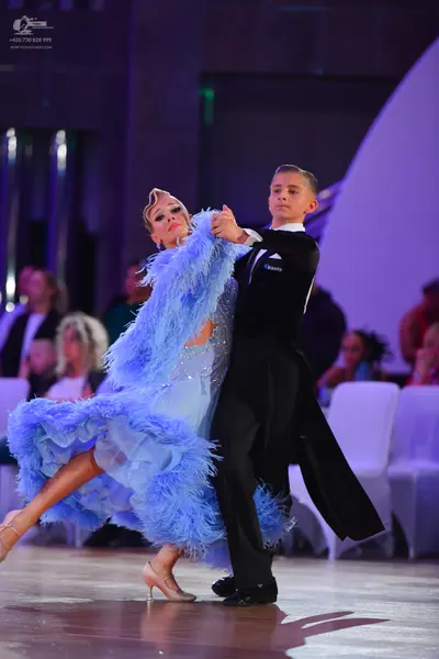 Dancesport competitor: Female dancer: light blue latin dress with a sequined bodice and a voluminous sk