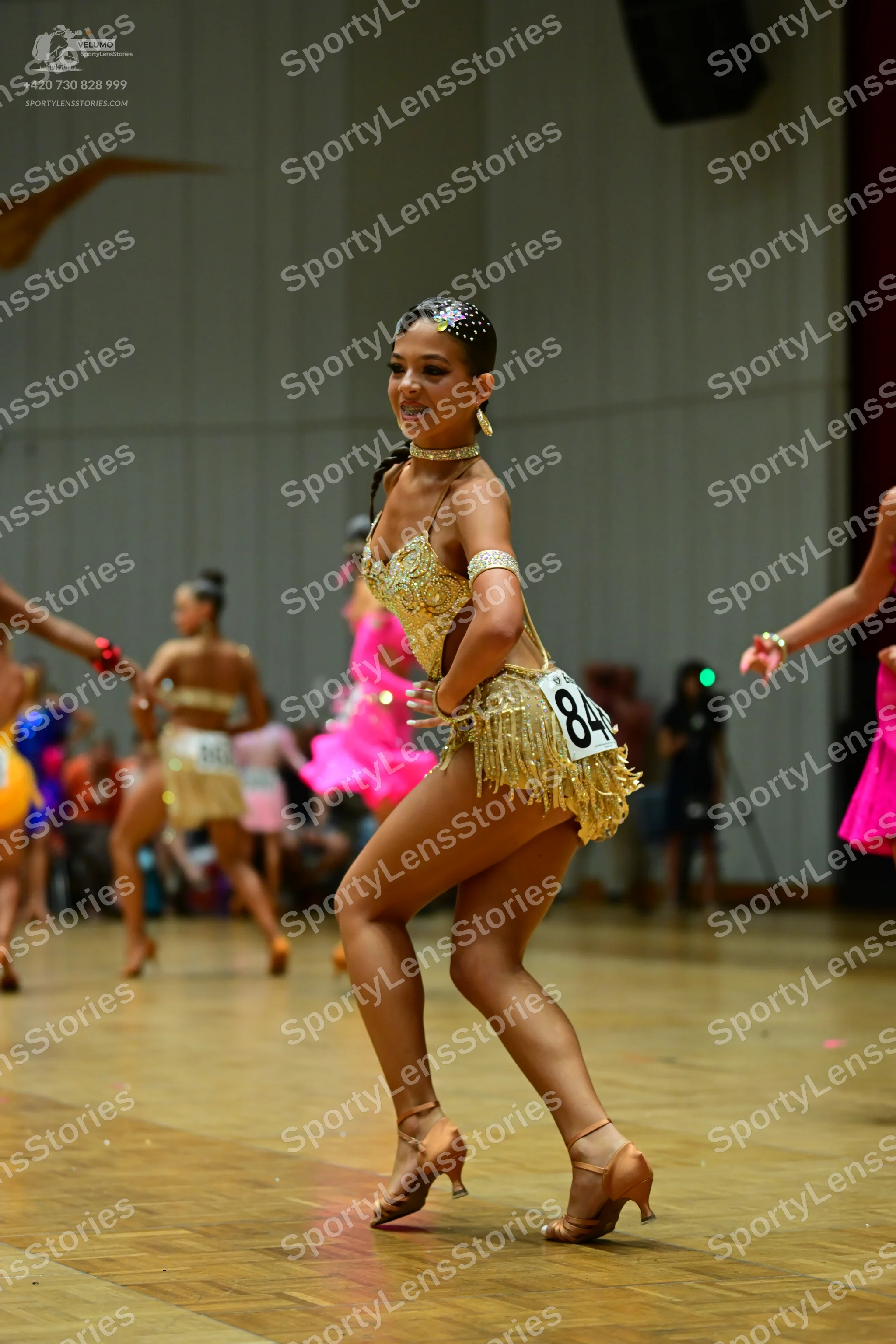 Dancesport competitor #84: Main dancer: gold latin dress with sequins on the bodice and fringe on the skirt