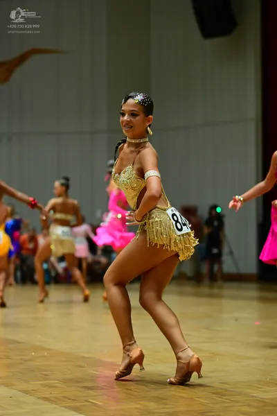 Dancesport competitor #84: Main dancer: gold latin dress with sequins on the bodice and fringe on the skirt