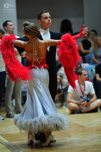 Dancesport competitor: Male dancer: black suit with a white shirt and white bow tie